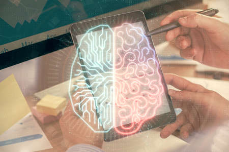 Double exposure of man's hand holding and using a digital device and brain hologram drawing. Data...