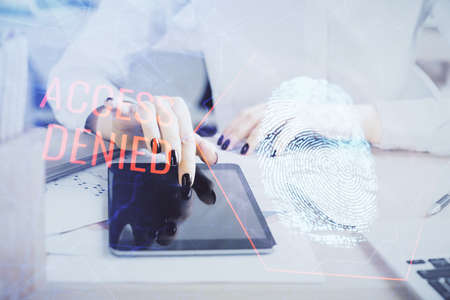 Double exposure of fingerprint hologram and woman holding and using a mobile device. Security...