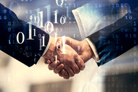 Double exposure of data theme hologram and handshake of two men. Partnership in IT industry concept.