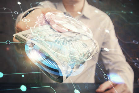 Double exposure of technology drawing hologram and us dollars bills and man hands. Data conceptの写真素材