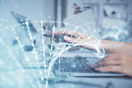 Double exposure of woman hands typing on computer and DNA hologram drawing. Medical education...