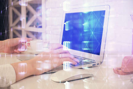 Double exposure of woman hands working on computer and data theme hologram drawing. Tech concept.