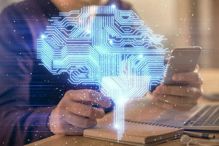Double exposure of man's hand holding and using a digital device and brain hologram drawing. Data concept.の写真素材