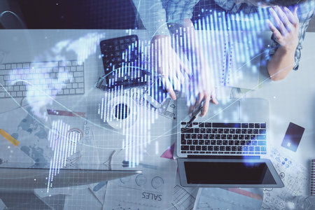 Double exposure of man and woman working together and business theme hologram drawing. Computer...