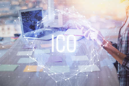 Double exposure of woman hands typing on computer and crypto market theme hologram drawing. Blockchain concept.の写真素材