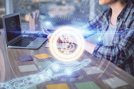 Double exposure of woman hands typing on computer and crypto market theme hologram drawing....