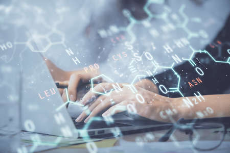 Double exposure of woman hands typing on computer and formula hologram drawing. Education concept.の写真素材