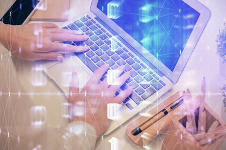 Double exposure of woman hands working on computer and data theme hologram drawing. Tech concept.