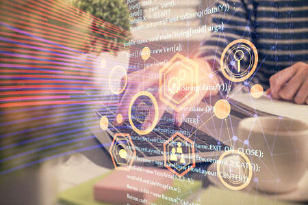 Double exposure of woman hands working on computer and data theme hologram drawing. Tech concept.の写真素材
