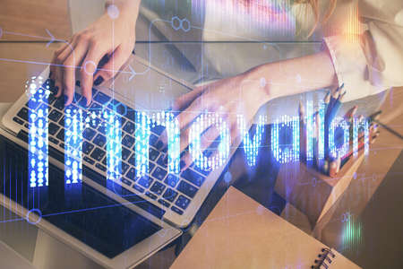 Double exposure of woman hands working on computer and data theme hologram drawing. Tech concept.の写真素材