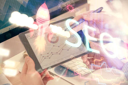Multi exposure of man's hands holding and using a digital device and seo drawing. search...