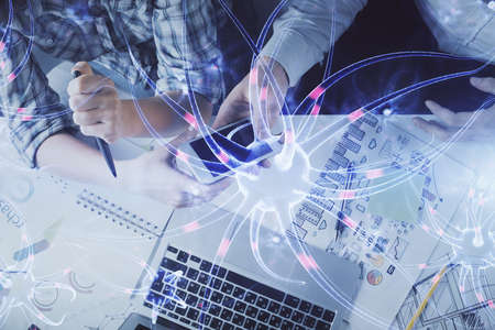 Double exposure of neuron drawing and man and woman working together holding and using a mobile...