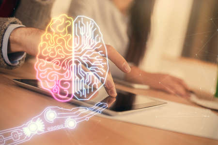 Double exposure of man and woman working together holding and using a mobile device and brain...