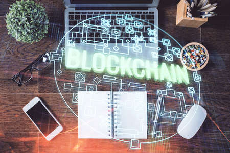 Blockchain theme hologram drawings over computer on the desktop background. Top view. Double exposure.の写真素材