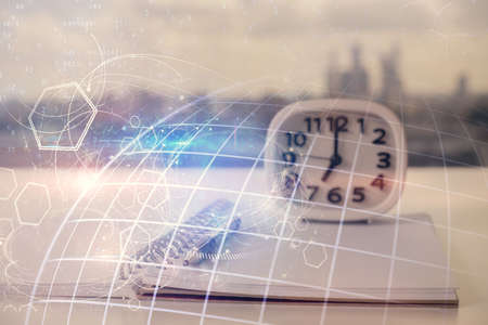 Multi exposure of world map drawings and desk with open notebook background. Concept of globolizationの写真素材