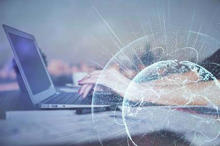 Double exposure of woman hands typing on computer and social network theme hologram drawing. People...