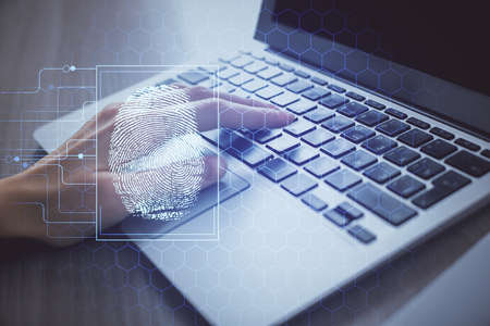 Double exposure of woman hands typing on computer and fingerprint drawing. Security concept.の写真素材