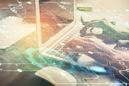 Double exposure of woman hands working on computer and data theme hologram drawing. Tech concept.