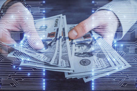 Multi exposure of Tech drawing hologram and USA dollars bills and man hands. Technology concept.