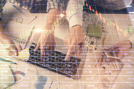 Multi exposure of man and woman working together and forex graph hologram drawing. Financial...