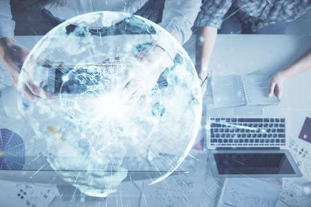 Double exposure of man and woman working together and business theme hologram drawing. Computer background. Top View.の写真素材