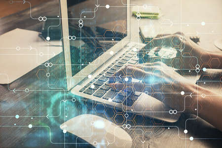 Double exposure of woman hands working on computer and data theme hologram drawing. Tech concept.