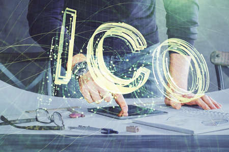 Double exposure of man's hands holding and using a phone and crypto currency blockchain theme drawing.の写真素材