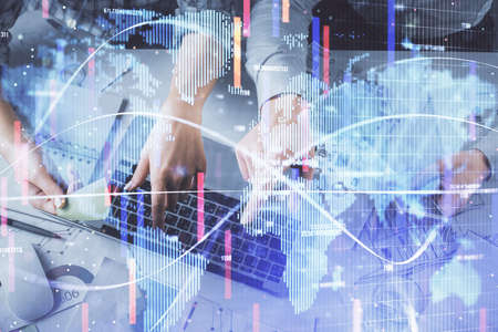 Double exposure of man and woman working together and business theme hologram drawing. Computer...