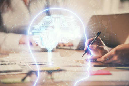 Multi exposure of woman hands working on computer and brain hologram drawing. Ai concept.の写真素材