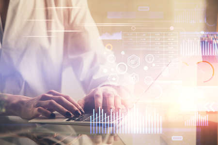 Double exposure of woman hands working on computer and data theme hologram drawing. Tech concept.