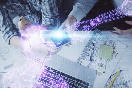 Double exposure of human hologram in VR glasses drawing and man and woman working together holding...