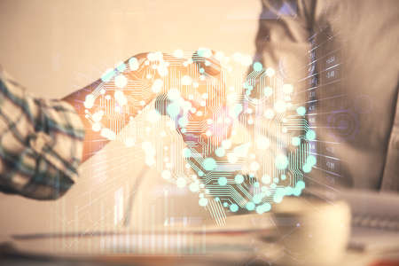 Double exposure of brain hologram and handshake of two men. Partnership in IT industry concept.