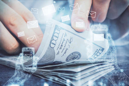 Multi exposure of envelop drawing hologram and USA dollars bills and man hands. Technology concept.の写真素材