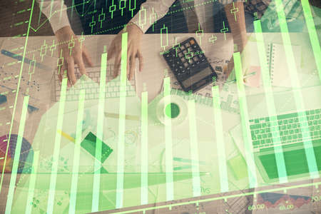 Double exposure of man and woman working together and financial chart hologram drawing. market...