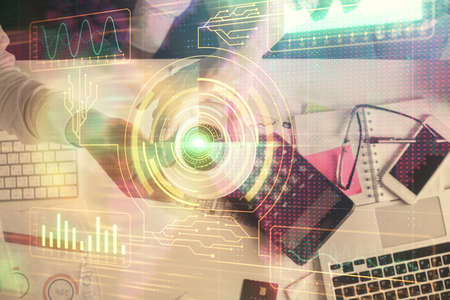 Double exposure of man and woman working together and data theme hologram drawing. Computer background. Top View.の写真素材