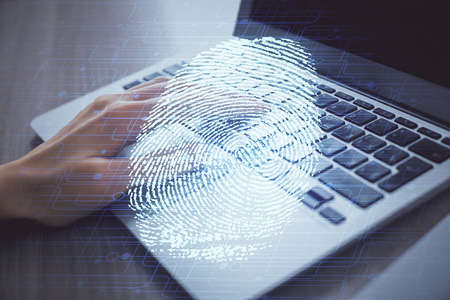 Double exposure of woman hands typing on computer and fingerprint drawing. Security concept.