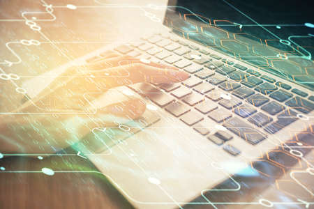 Double exposure of woman hands working on computer and data theme hologram drawing. Tech concept.