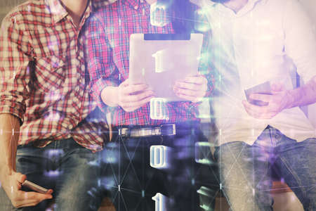 Double exposure of data theme hologram drawing and man and woman working together holding and using a mobile device.の写真素材