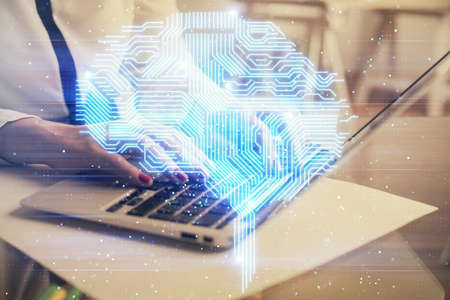 Multi exposure of woman hands working on computer and human brain hologram drawing. Ai tech concept.