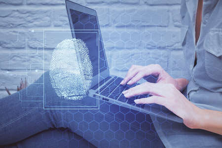 Double exposure of woman hands typing on computer and fingerprint drawing. Security concept.