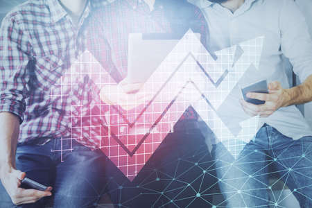 Double exposure of arrows drawing and man and woman working together holding and using a mobile...