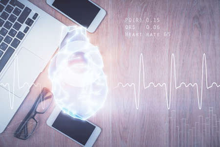 Double exposure of heart drawing over table with phone. Top view. Medical education concept.