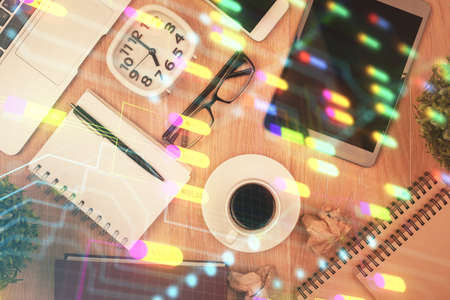 Double exposure of technology theme drawing over work table desktop. Top view. Global data analysis...
