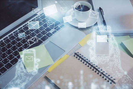 Double exposure of envelope drawing and desktop with coffee and items on table background. Concept...