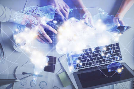 Double exposure of man and woman working together and business theme hologram drawing. Computer...
