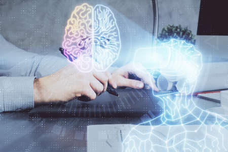 Double exposure of man's hands holding and using a digital device and AR glasses drawing. Virtual...