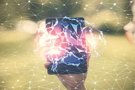 Double exposure of brain sketch hologram and woman holding and using a mobile device.