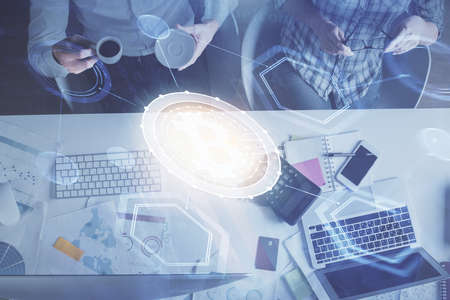 Double exposure of man and woman working together and crypto theme hologram drawing. Computer background. Blockchain concept. Top View.の写真素材
