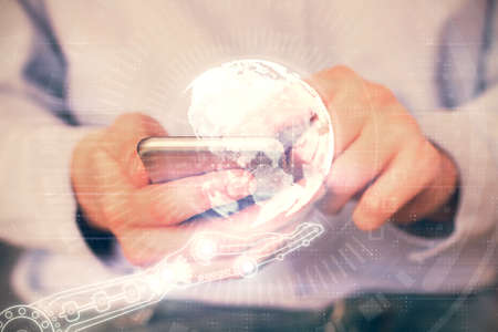 Multi exposure of man's hands holding and using a digital device and map drawing. International...