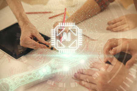 Double exposure of data theme hologram drawing and man and woman working together holding and using a mobile device.の写真素材